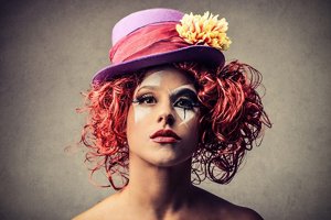 Woman dressed as a clown with short red curly hair
